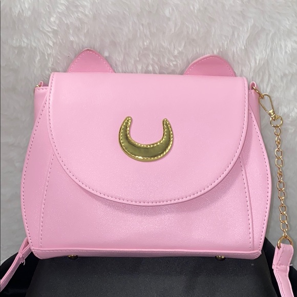 Hot Topic Handbags - ⬇️NWOT Sailor Moon inspired Pink and Gold Crossbody Bag with Cat Ears
